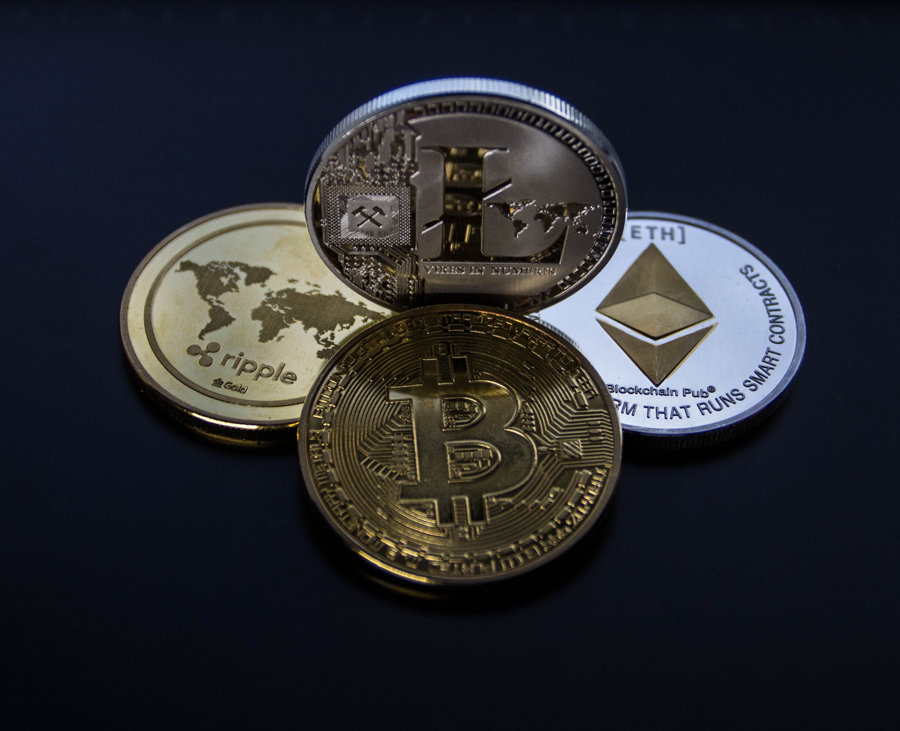 Physical cryptocurrency coins, representing Bitcoin and Ethereum